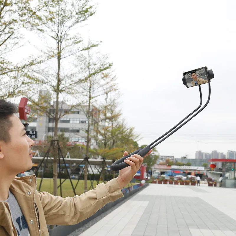 Baseus flexible gooseneck phone holder with clamp and shockproof support, shown holding a mobile phone.