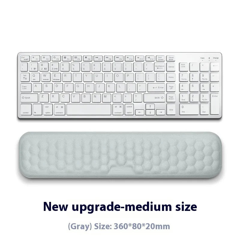 Memory foam mouse wrist pad with silicone bottom in black cloth cover on computer desk