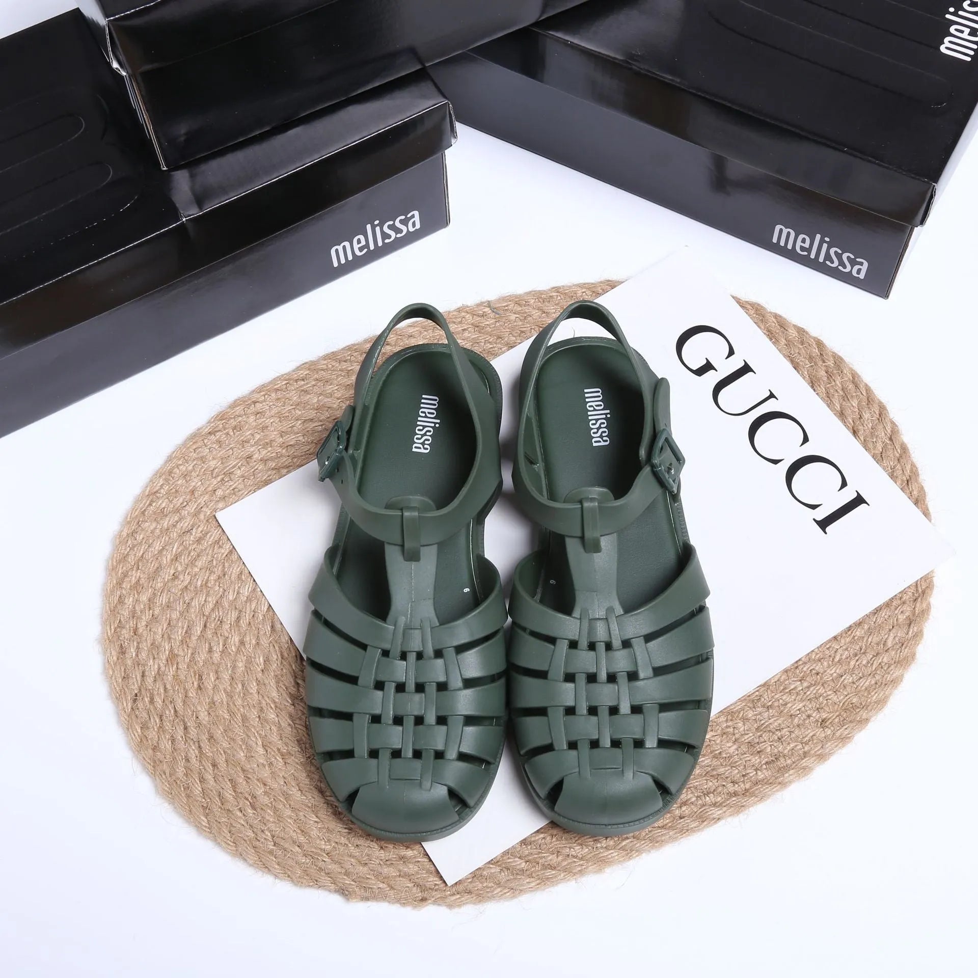 Matte black vintage weave Roman sandals with buckle closure and round toe on a white background.