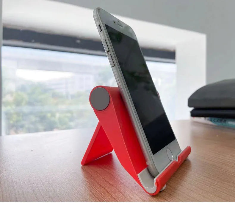 Black PE folding tablet stand holding a mobile phone at an adjustable angle