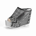 Women's black platform sandals with a lace-up ankle strap and hollowed-out chunky heel.