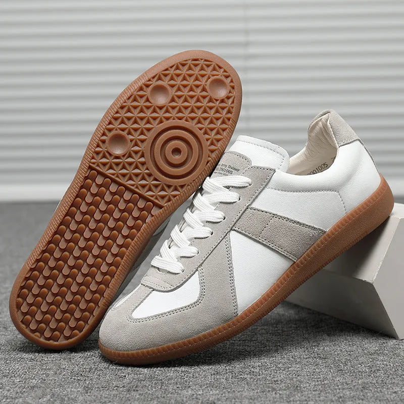 White Japanese retro low-top sneakers with matte finish and visible stitching on a rubber sole.