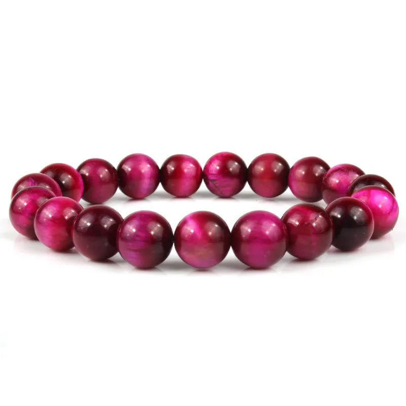 Natural tigereye crystal beaded bracelet with round beads, shown in a selection of colours and sizes on a wrist.