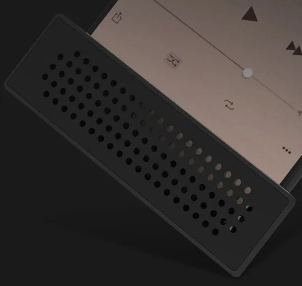 Mini black ABS plastic mobile phone amplifier bracket holding a smartphone on a desktop.