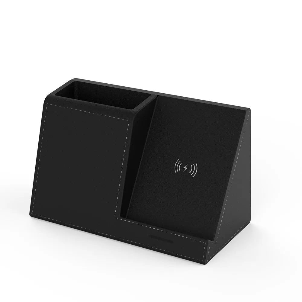 Black leather pen holder with integrated wireless phone charging pad on a desk.