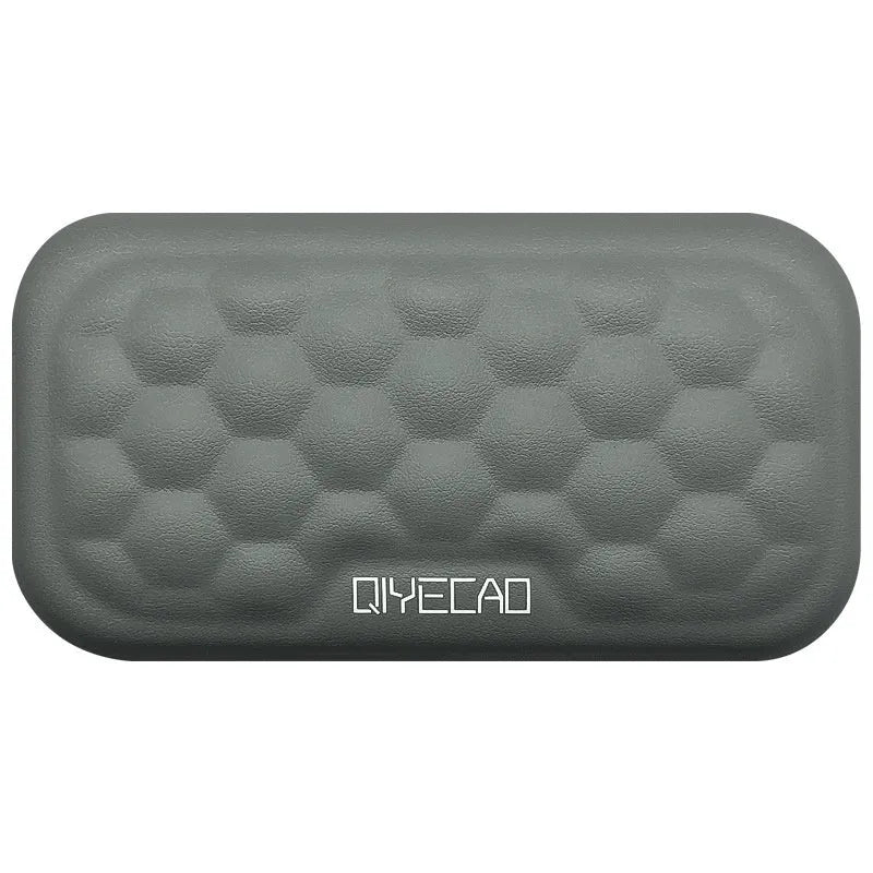 Memory foam mouse wrist pad with silicone bottom in black cloth cover on computer desk