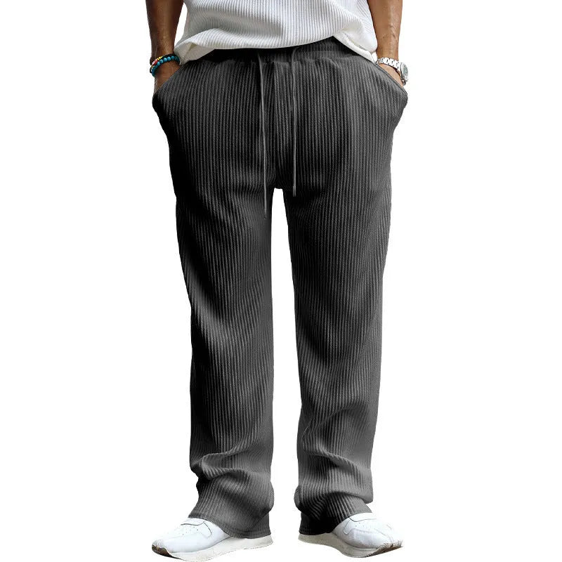 Man wearing loose fit high-waist straight leg casual trousers in Army Green.