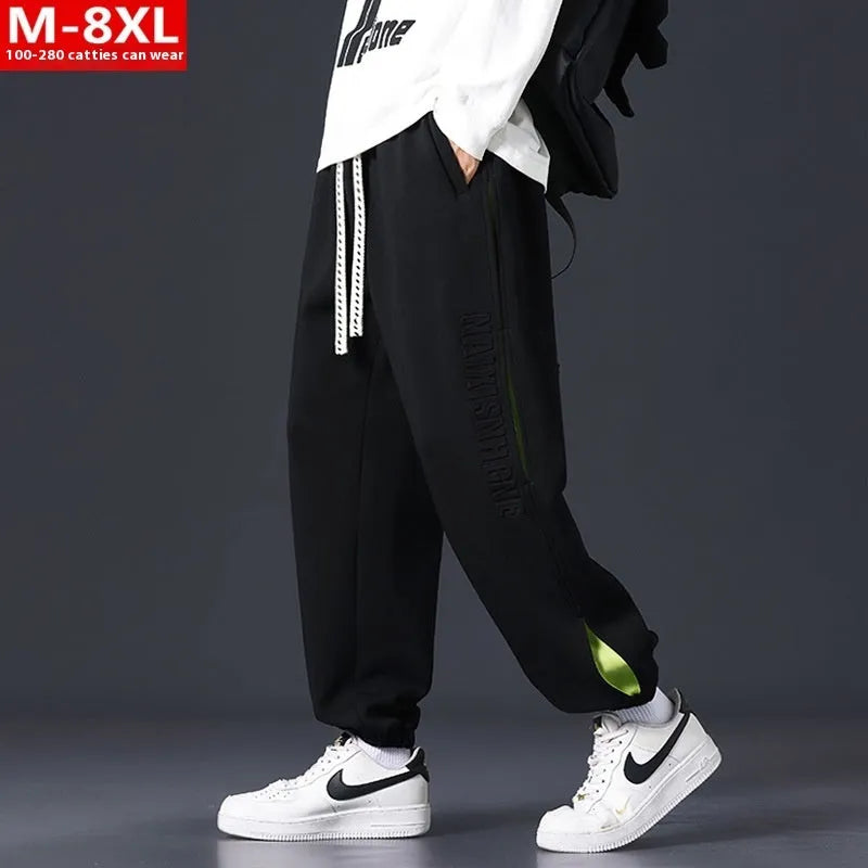 Men's loose-fit ankle banded cotton trousers with stitching detailing and skinny leg opening in grey green colour