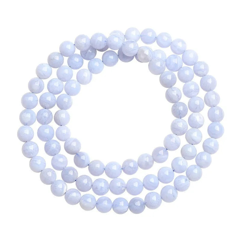 Blue multi-circle patterned agate bracelet with scattered 6-6.8mm beads and Ruyi design detail on a white background.