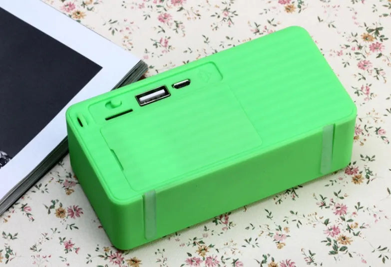 Cannon X3 small cube-shaped wireless Bluetooth portable speaker in red colour on a table
