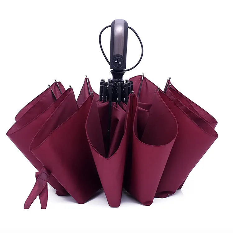 Black triple folding automatic business umbrella with steel ribs and a rubber handle.