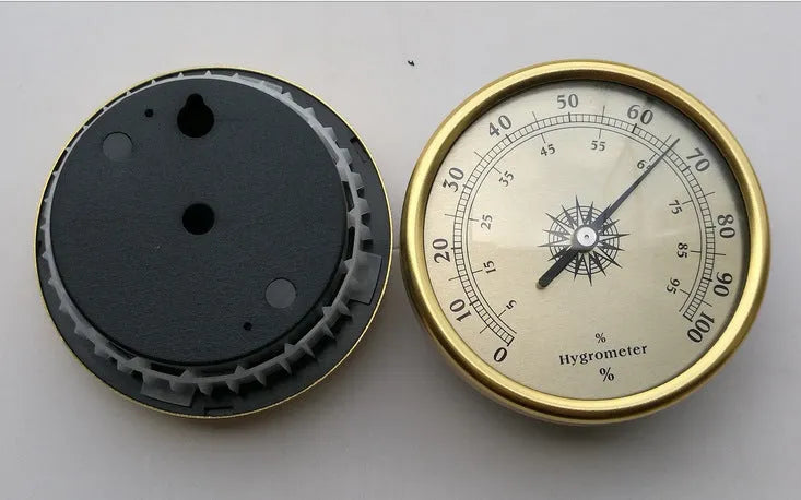 Silver aluminium analog thermometer and hygrometer with a round dial showing temperature and humidity scales.