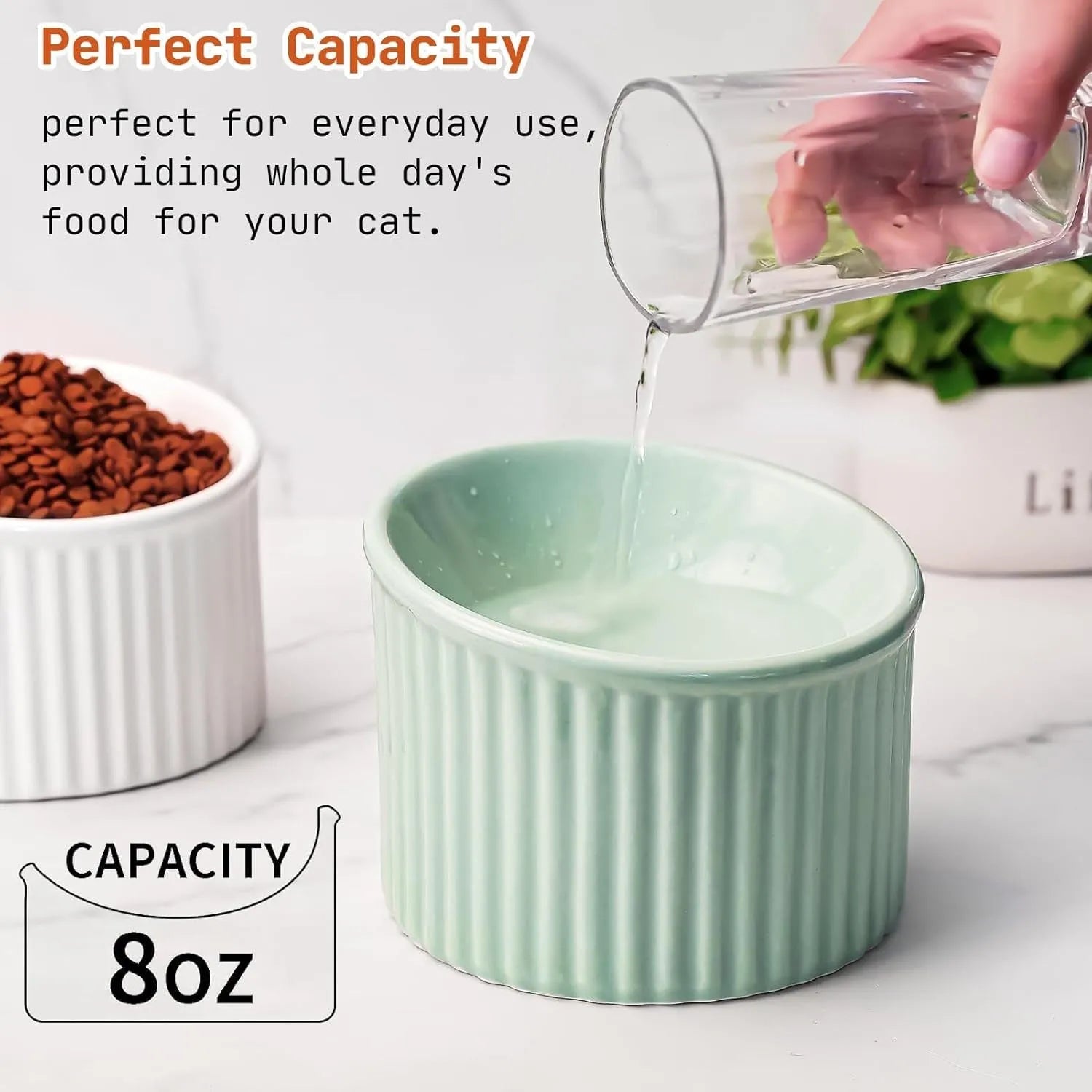 Dark green ceramic elevated cat bowl with round, whisker-friendly shape on a tilted base.