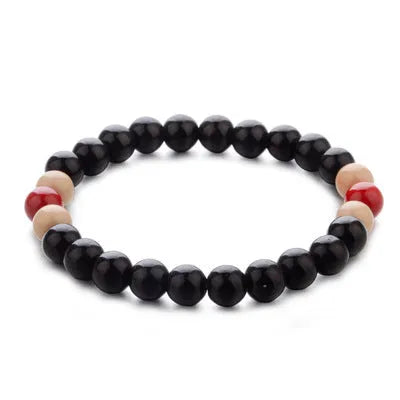 A natural lava stone bead bracelet with ethnic style on a wrist, demonstrating its unisex aromatherapy design.
