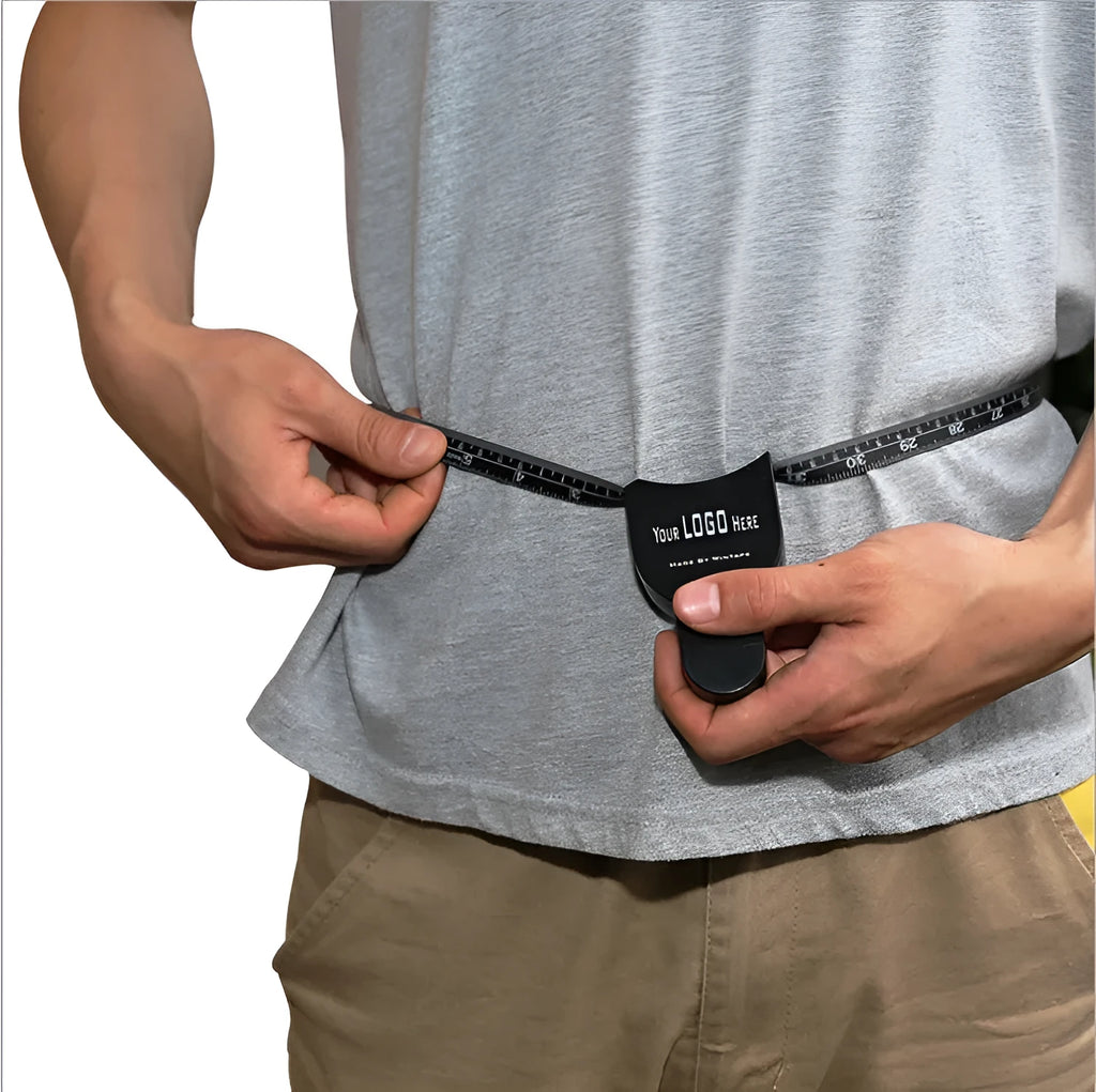 Black ABS plastic body fat caliper skinfold measuring instrument on a tape measure