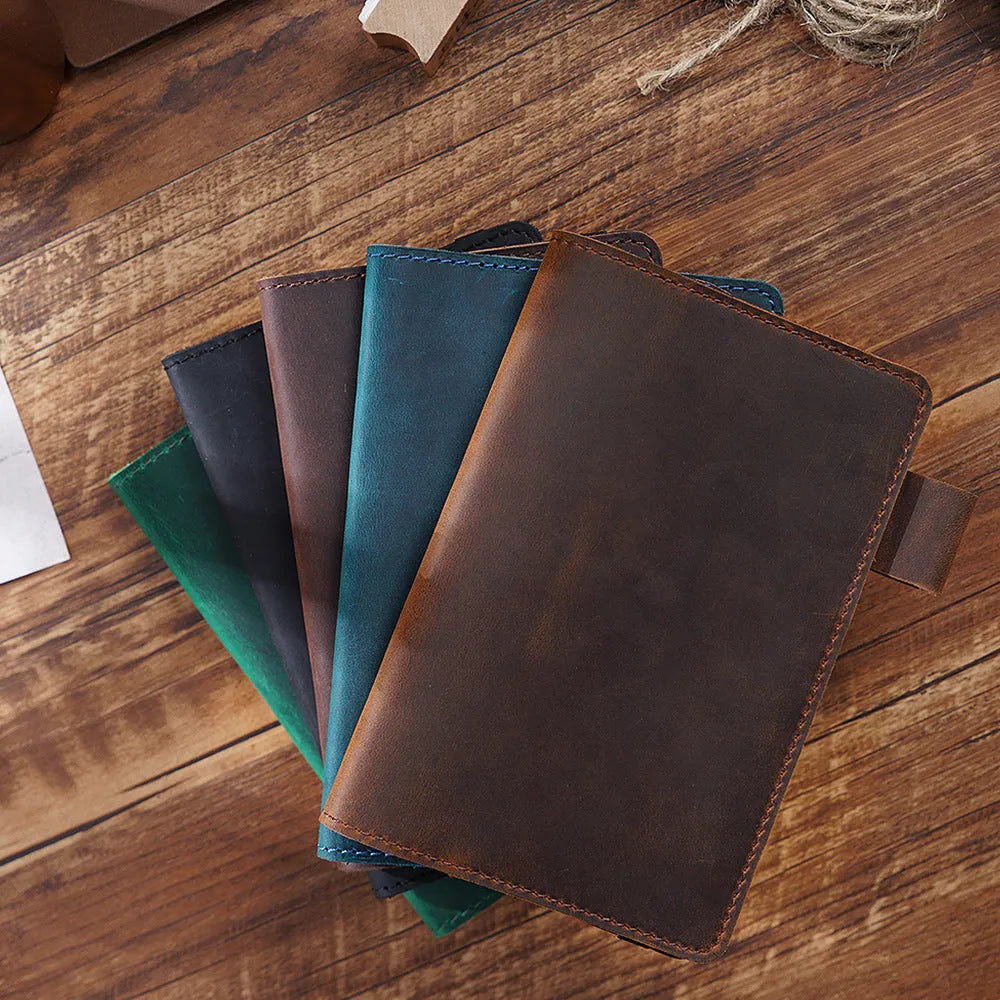 Handmade cowhide leather notebook open showing 100g wood-free paper with dark green cover