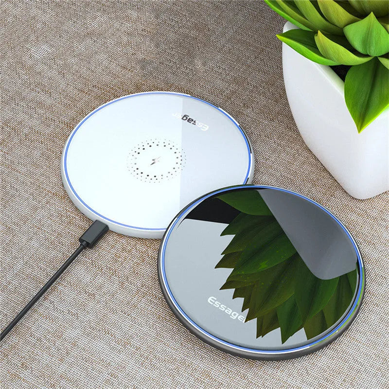 Black 15W Qi fast wireless charging pad with aluminium body and LED light, shown next to a smartphone.