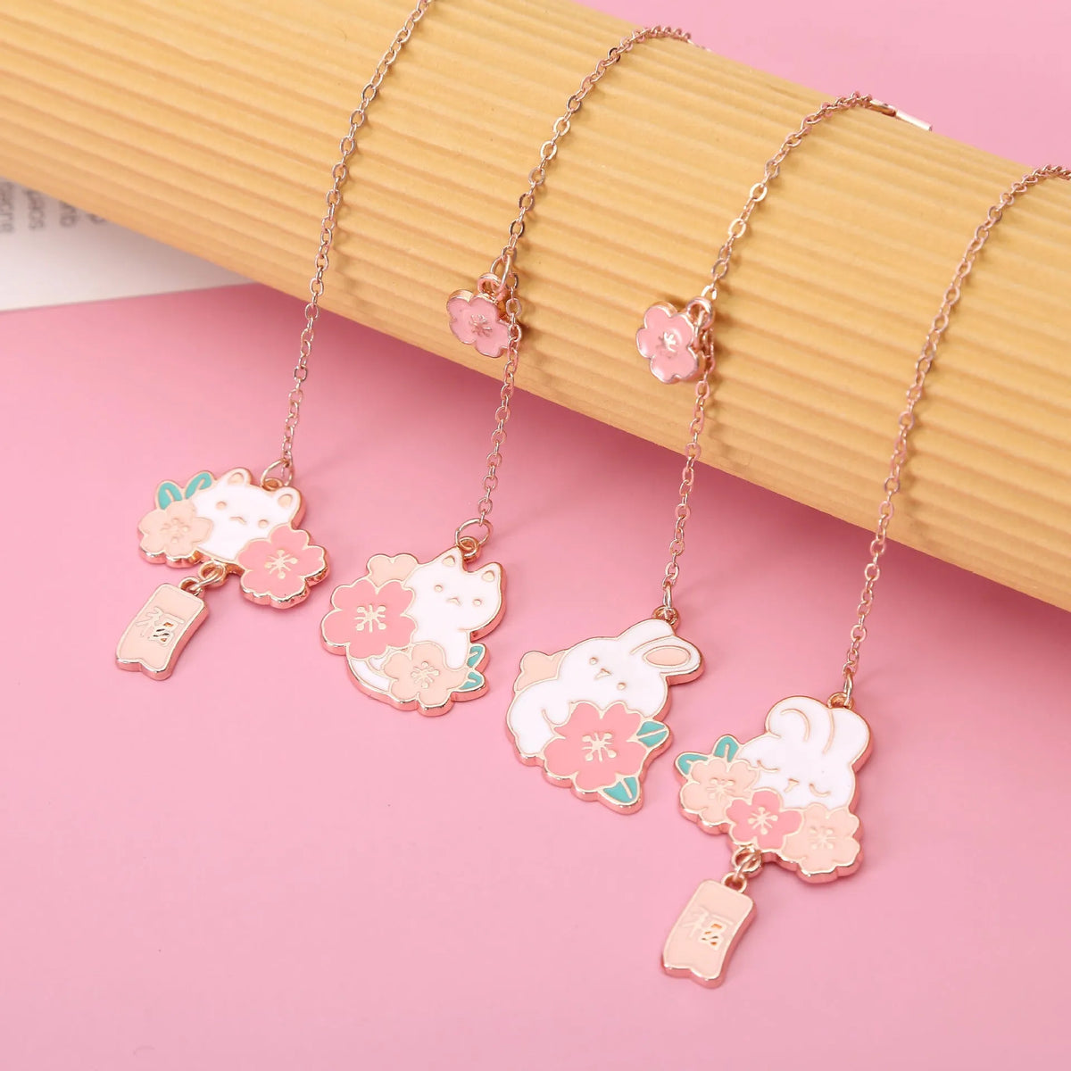 Cute cartoon metal bookmark pendant featuring a cherry cat or sakura rabbit design with sakura blossoms or a fu character.
