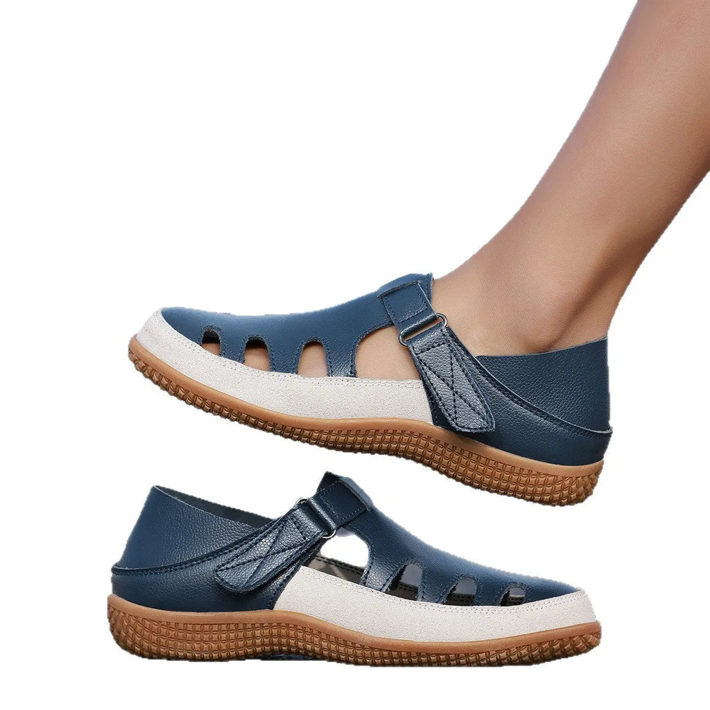 Plus size women's flat sandals in blue with a hollow toe cap and thick rubber sole.