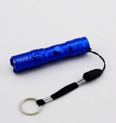 Black aluminium mini LED flashlight showing compact 9.5cm size with AA battery for scale