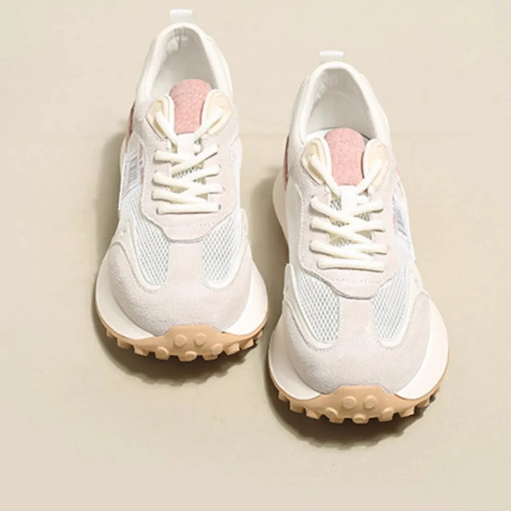 Women's grey and pink retro low-top sneaker with round toe and rubber sole.