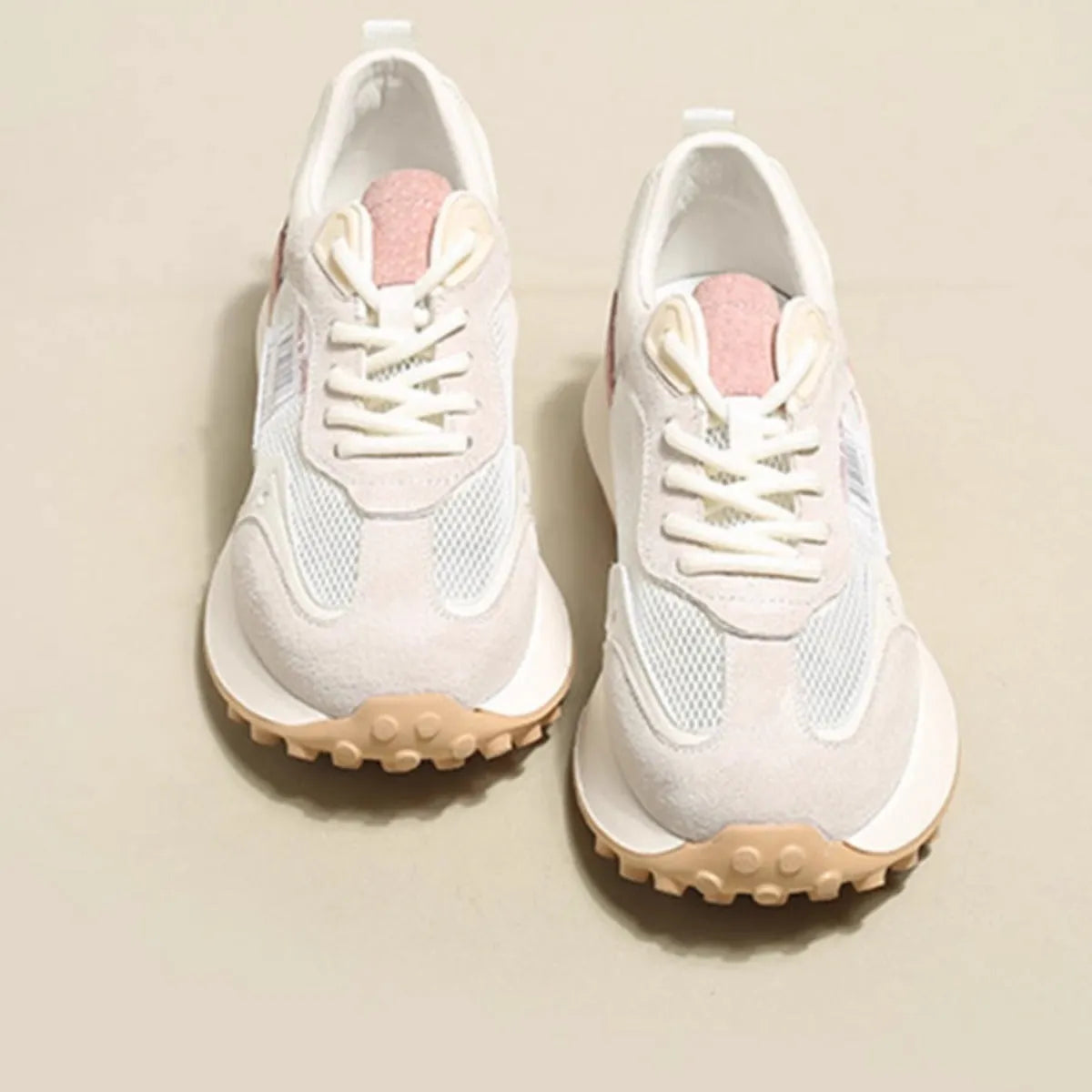Women's grey and pink retro low-top sneaker with round toe and rubber sole.