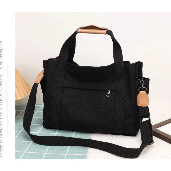 Large horizontal square canvas tote bag in army green with visible sewing lines and open zipper sides.