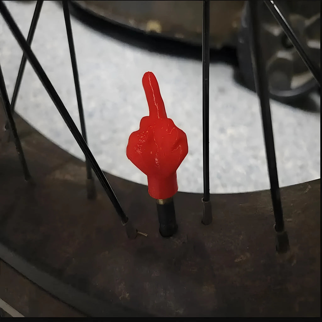 Four latex car tyre valve dust caps showing black and skin colour pieces for valve stem protection