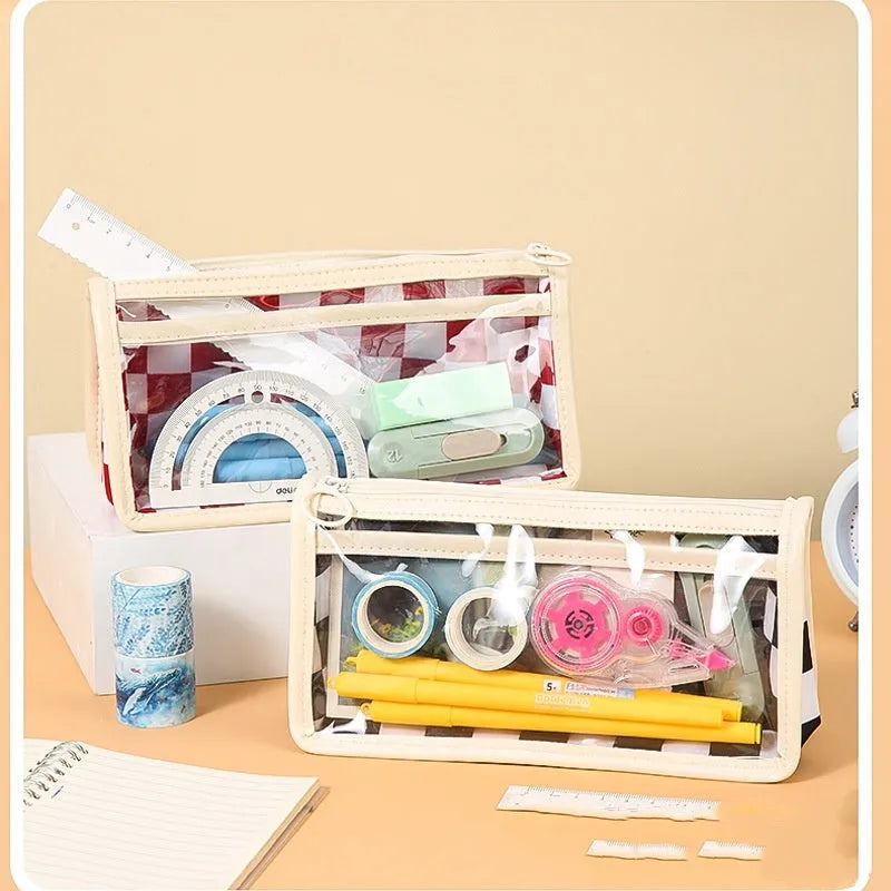 Transparent PVC pencil case with chessboard pattern showing pens inside, dimensions 21.5x8x11.5cm