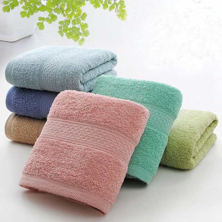 Thickened cotton blend bath towel shown in apple green colour on a bathroom rail.