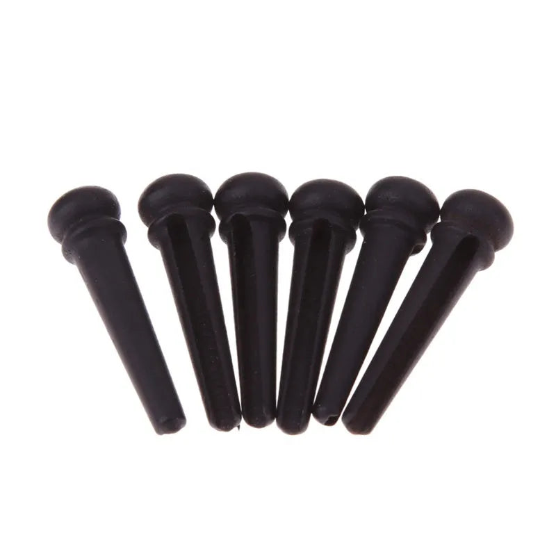 Set of six matt black ebony guitar bridge pins with 5.3mm diameter for folk acoustic guitars.