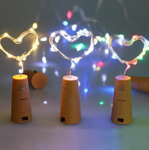 Flexible copper wire LED string lights wrapped around wine bottle with warm white illumination
