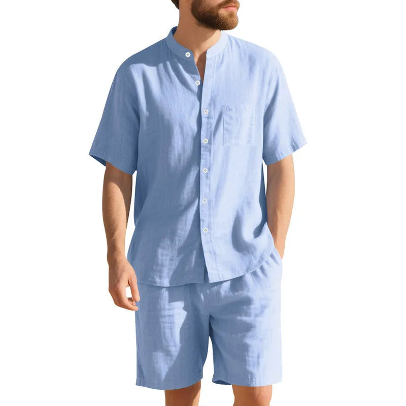Men's light blue linen two-piece suit with short-sleeved henry collar shirt jacket and shorts on a hanger.