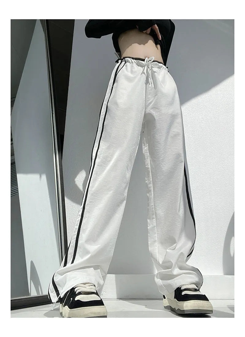 Women's navy blue loose straight leg trousers with white ribbon contrast pattern detail