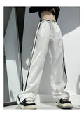 Women's navy blue loose straight leg trousers with white ribbon contrast pattern detail