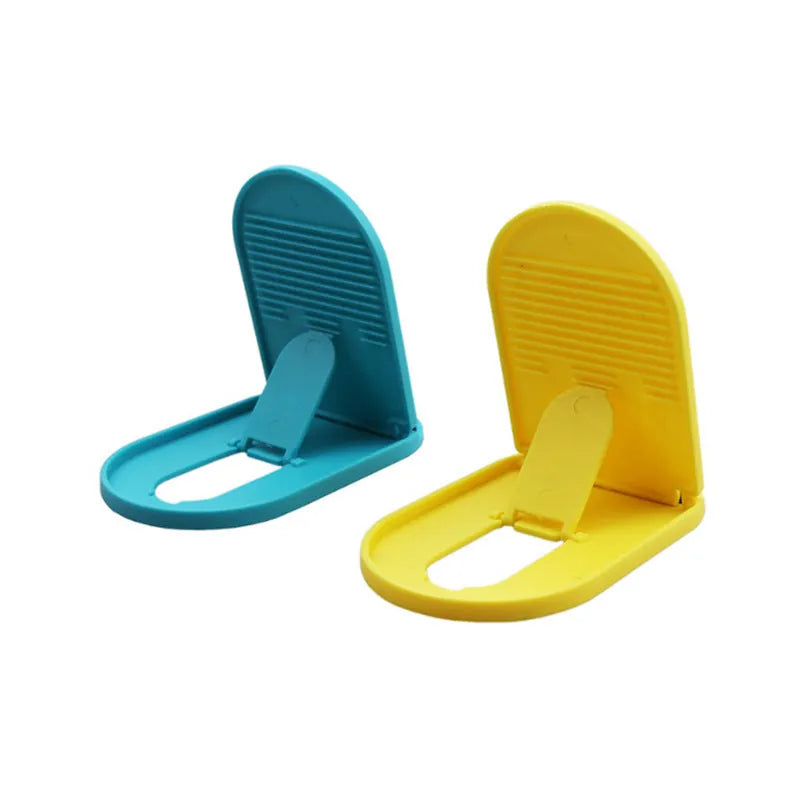 A plastic lazy bracket mobile phone stand holding a smartphone, shown in multiple colour options.