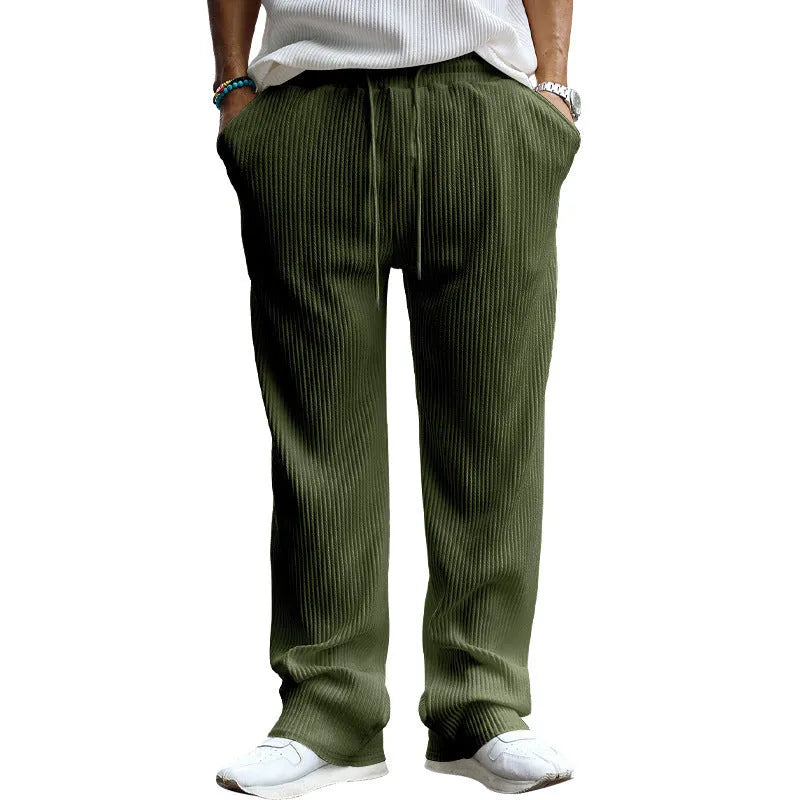 Man wearing loose fit high-waist straight leg casual trousers in Army Green.