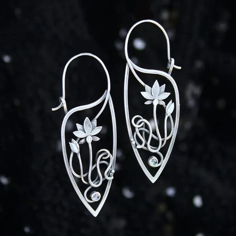A pair of silver women's earrings with a lotus vine and geometric design featuring round rhinestones.