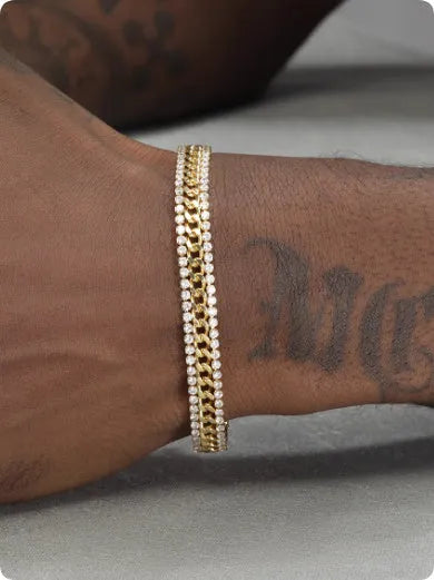 Gold-coloured titanium steel tennis bracelet with inlaid artificial gemstones on a wrist.