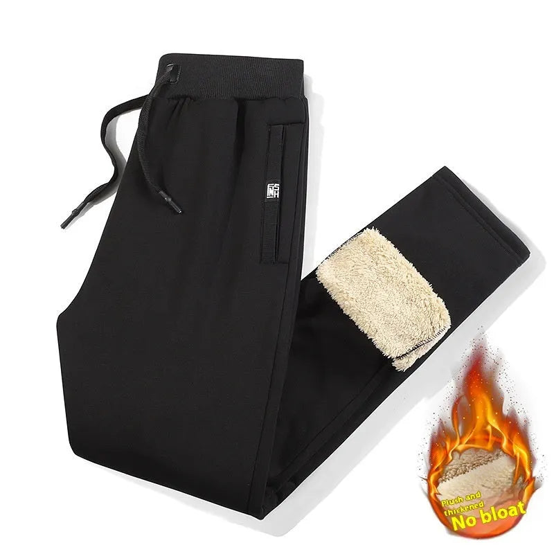 Men's grey fleece-lined oversized track pants with elastic waistband on hanger