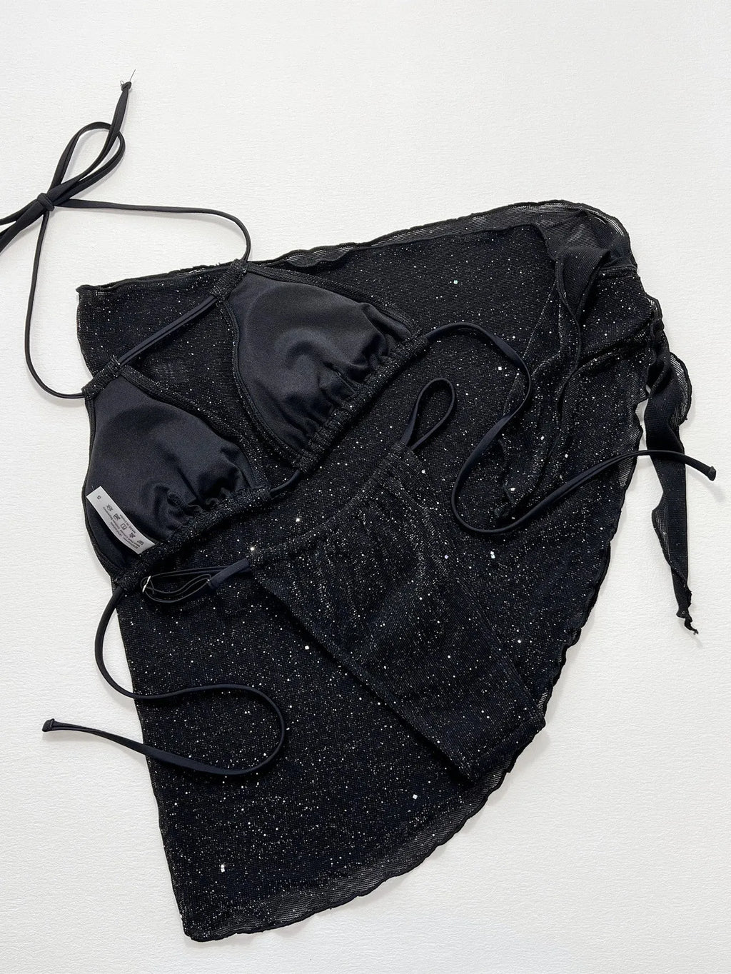 Black three-piece bikini set with bra top and shorts on a mannequin.