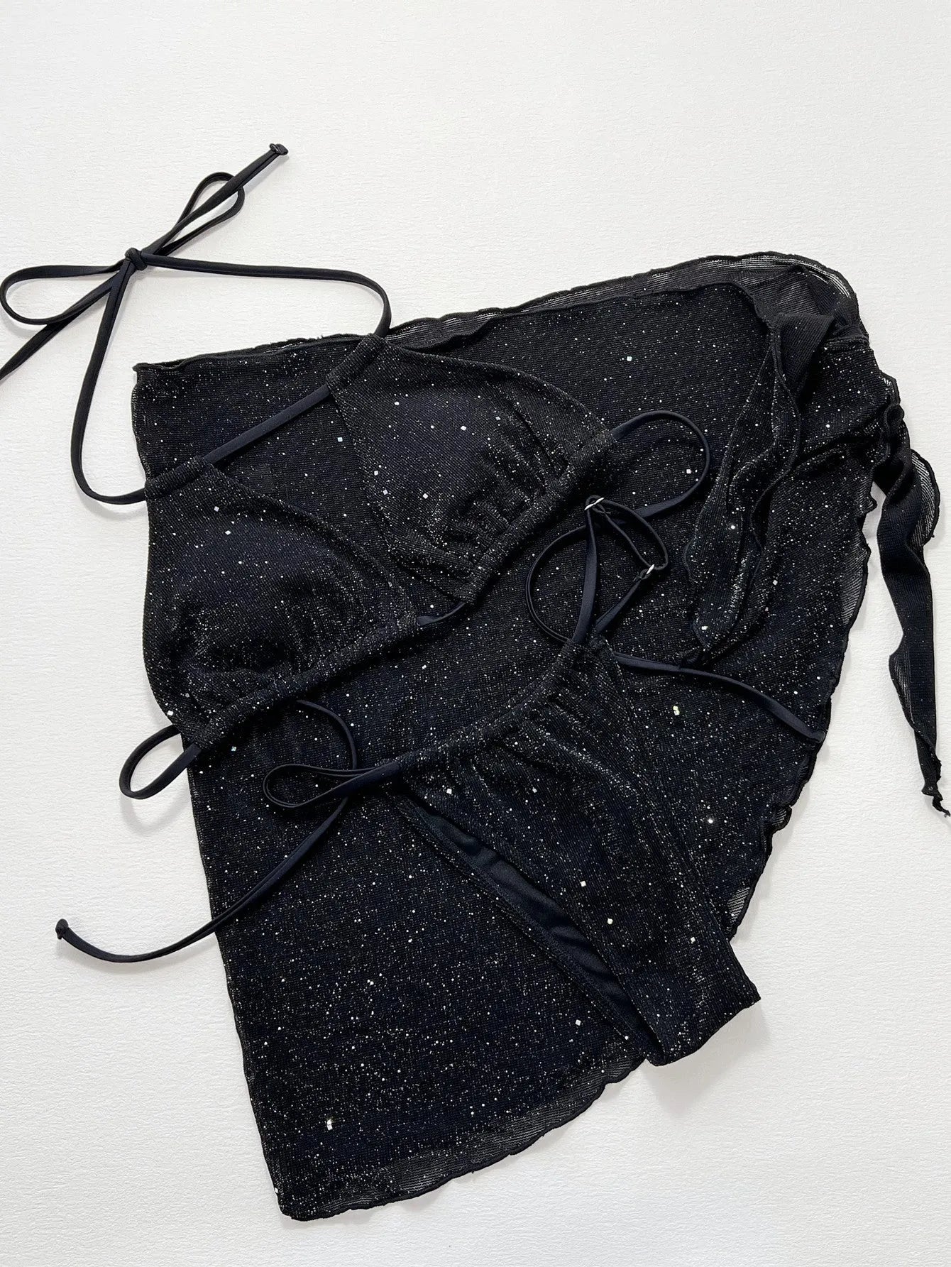 Black three-piece bikini set with bra top and shorts on a mannequin.