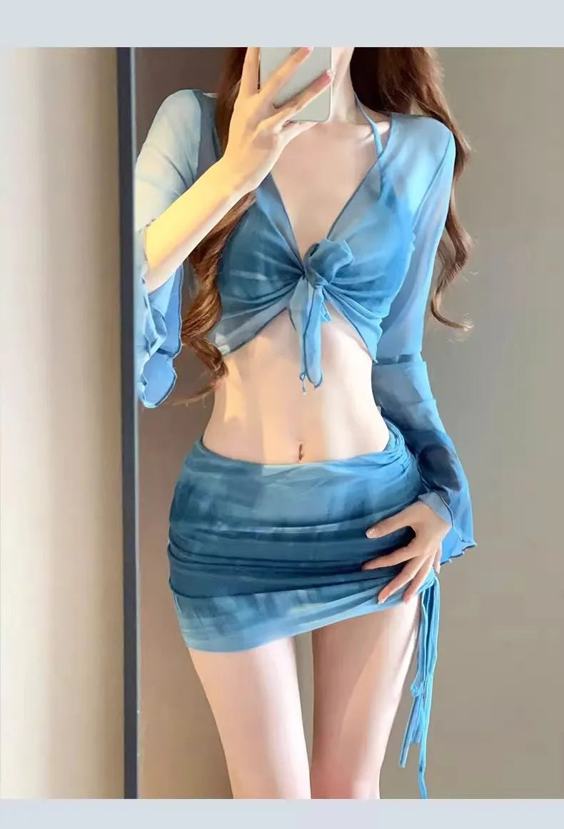 Blue high-waisted women's bikini set with matching shirt and skirt laid flat.