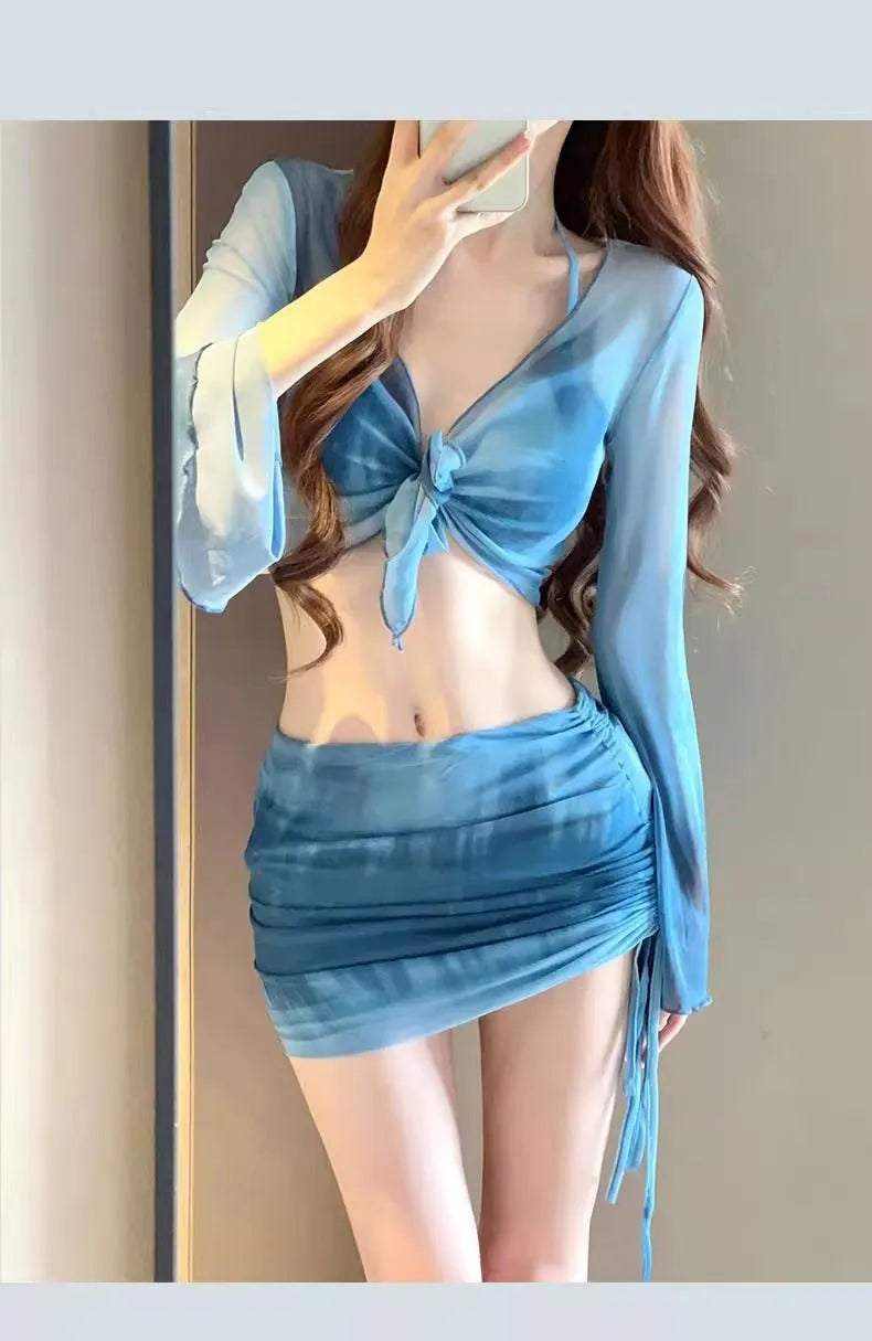 Blue high-waisted women's bikini set with matching shirt and skirt laid flat.