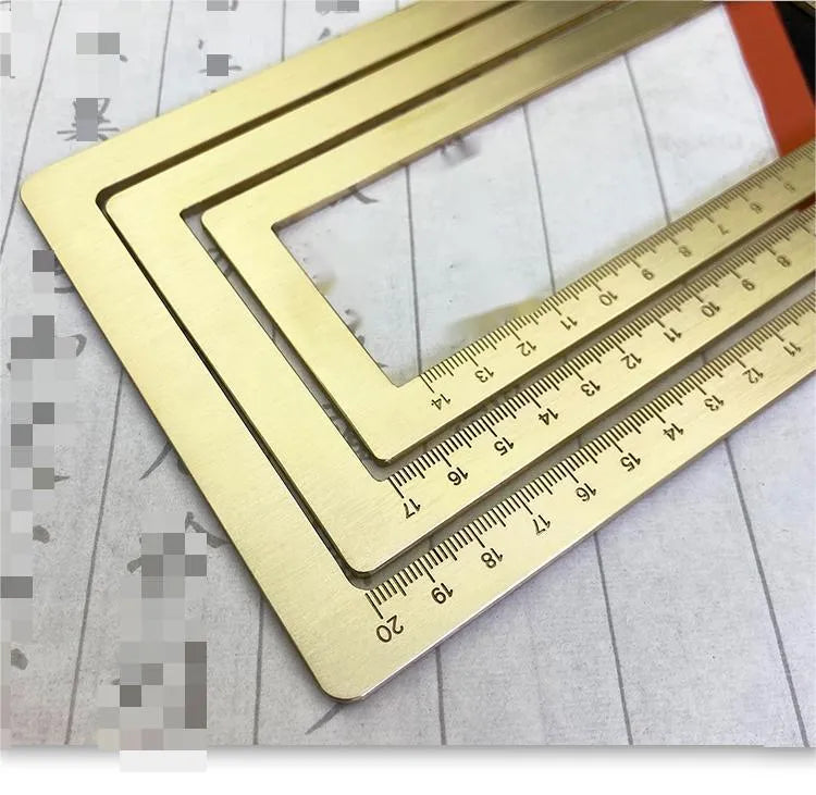 Solid brass square calligraphy paper weight with engraved design on a wooden desk.