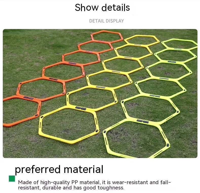 Set of six foldable yellow green and orange hexagon plastic agility training rings laid out on grass