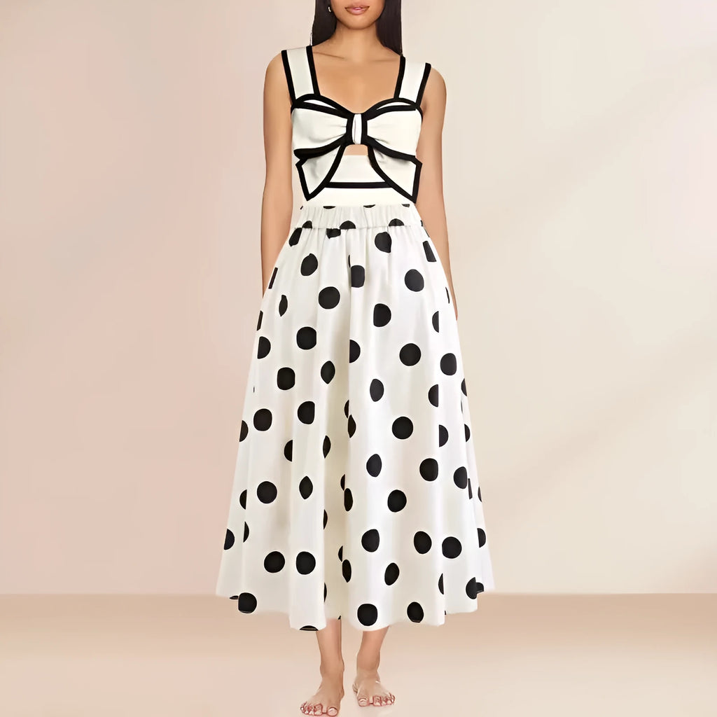 Women's black one-piece swimsuit with a white bow and round skirt on a mannequin.