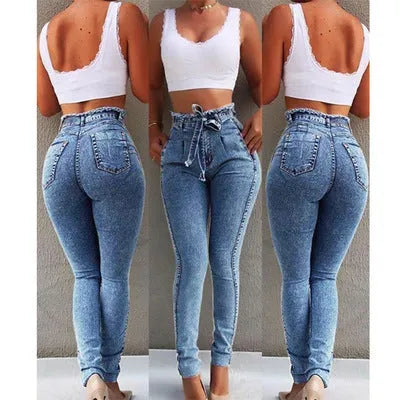 A pair of distressed grey fringed jeans made from Cowboy denim fabric on a neutral background.