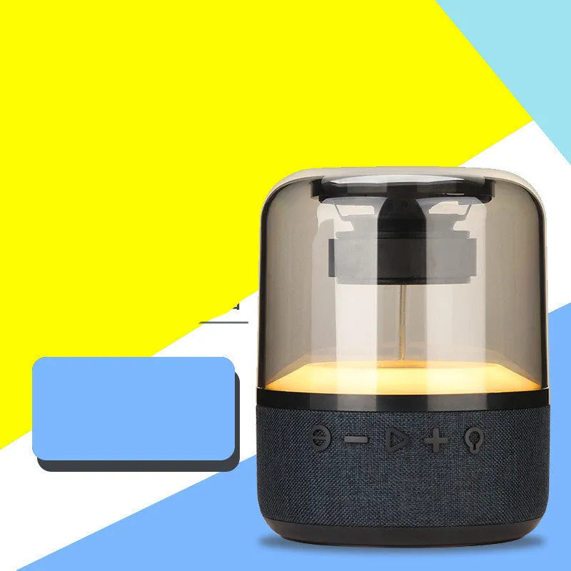 Black Four-Colour Light Touch Wireless Bluetooth Speaker with illuminated controls on a dark surface.
