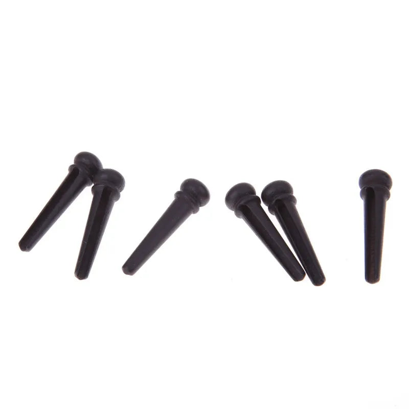 Set of six matt black ebony guitar bridge pins with 5.3mm diameter for folk acoustic guitars.